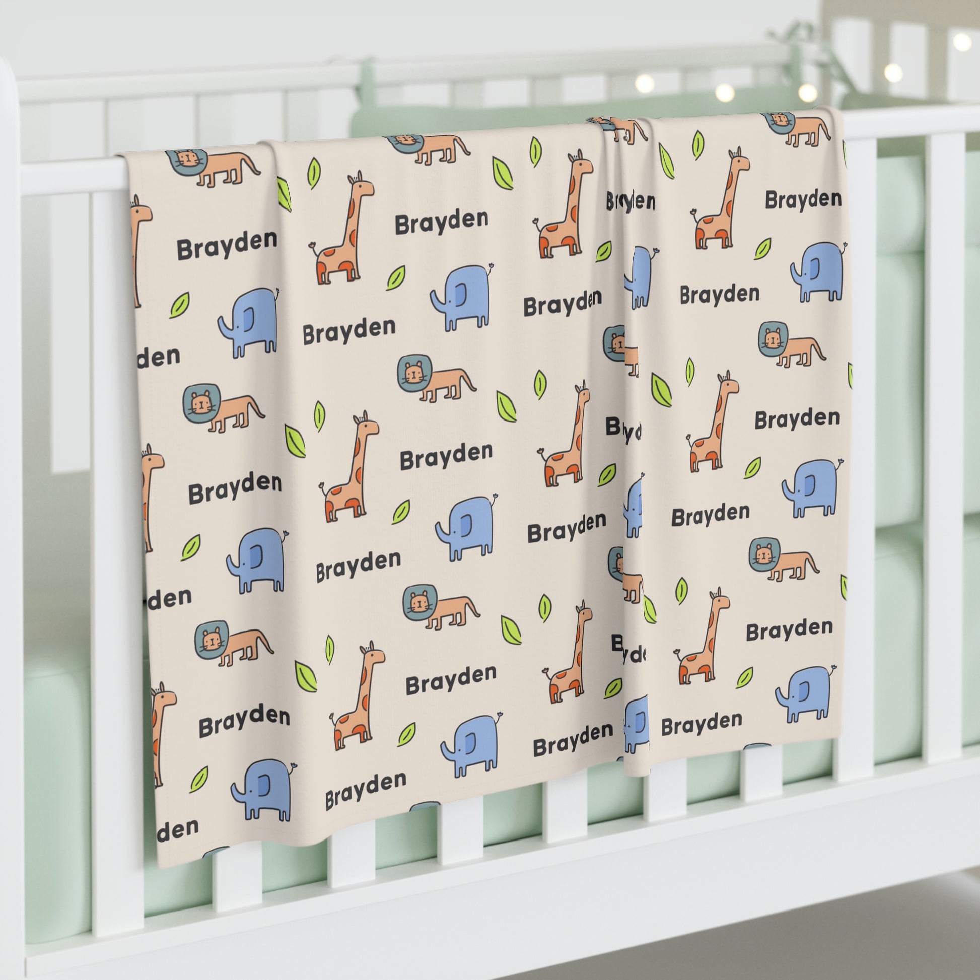 Jersey personalized baby blanket in safari animal pattern hung over side of white crib