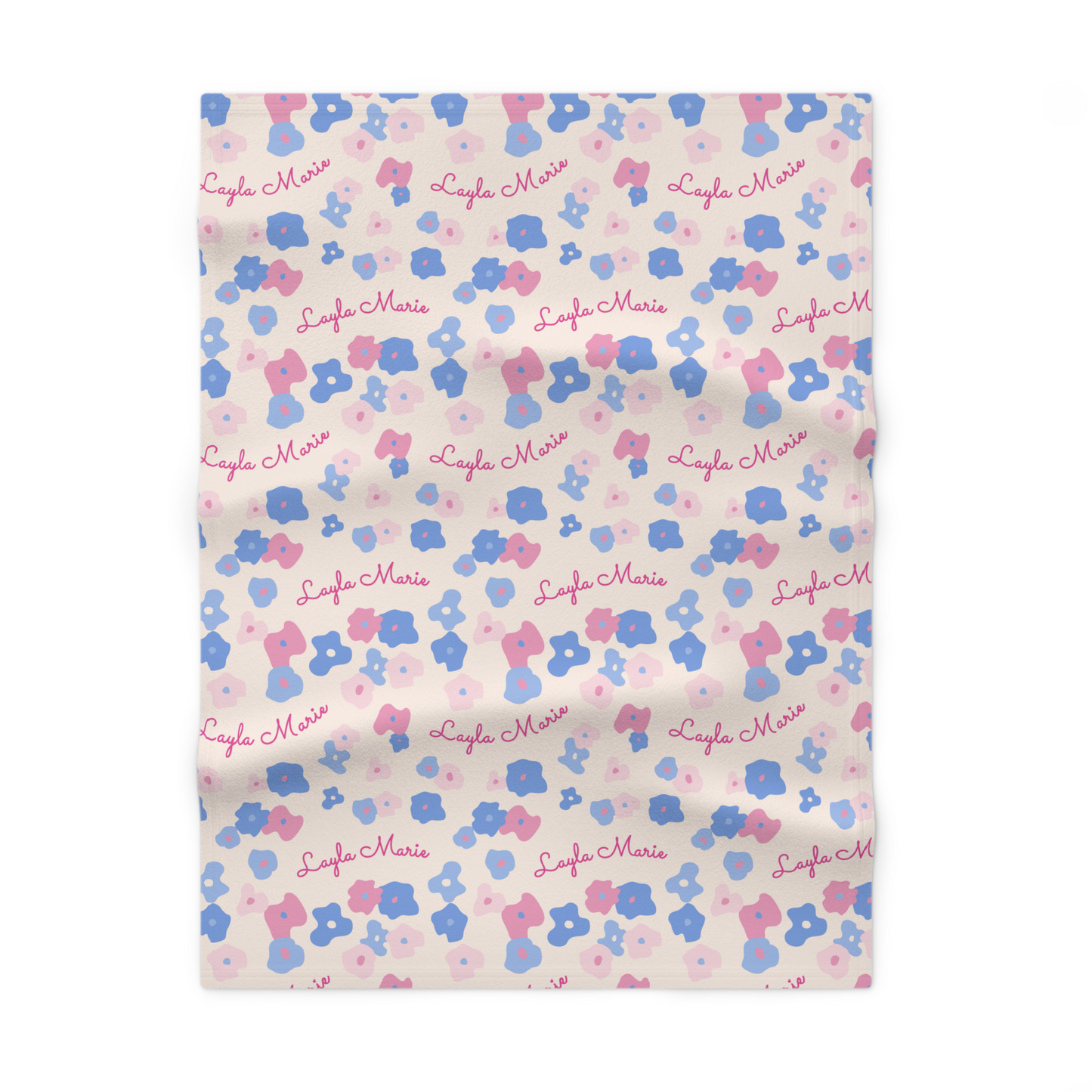Fleece personalized baby blanket in graphic pink and blue daisy pattern laid flat