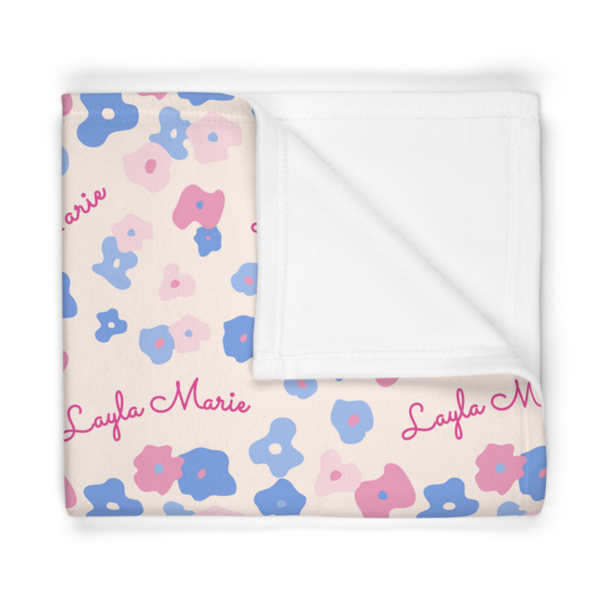 Folded fleece fabric personalized baby blanket in graphic pink and blue daisy pattern