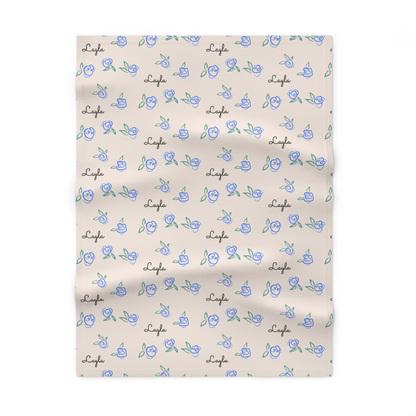 Fleece personalized baby blanket in blue rose pattern laid flat