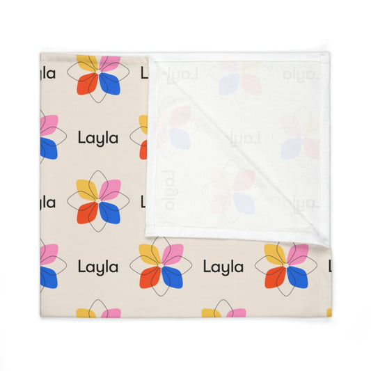 Folded jersey fabric personalized baby blanket in a multi-colored geometric boho flower pattern