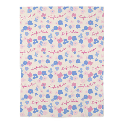 Jersey personalized baby blanket in graphic pink and blue daisy pattern laid flat