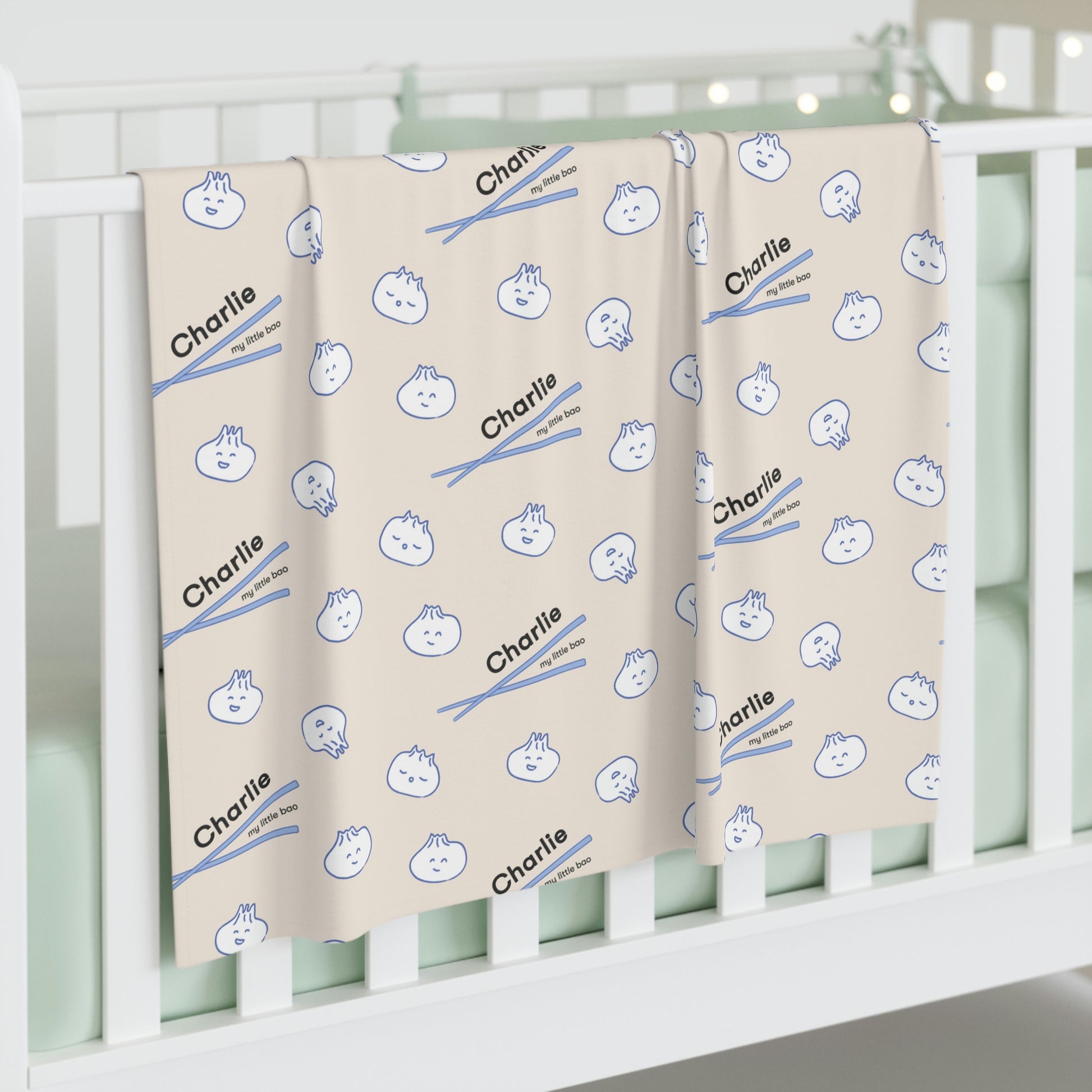 Jersey personalized baby blanket in bao pattern hung over side of white crib