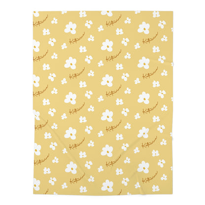 Jersey personalized baby blanket in yellow daisy pattern laid flat