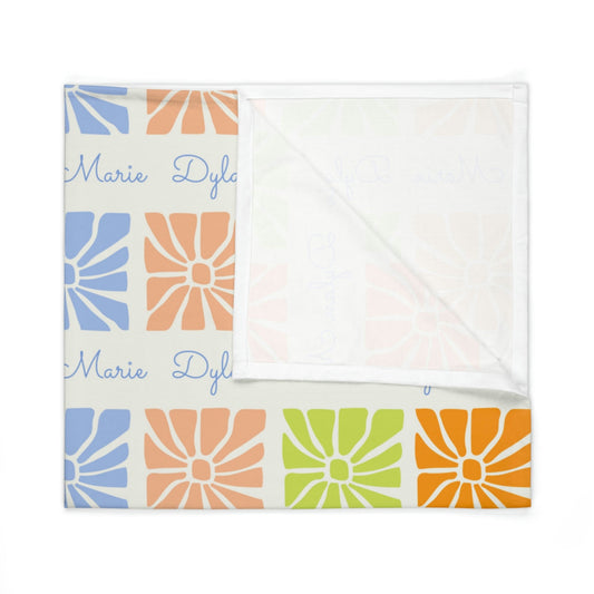 Folded jersey fabric personalized baby blanket in a multi-colored boho flower pattern