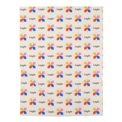 Jersey personalized baby blanket in a multi-colored boho geometric flower pattern laid flat