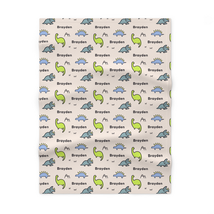 Fleece personalized baby blanket in dinosaur pattern laid flat