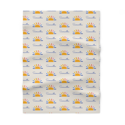 Fleece personalized baby blanket in sun pattern laid flat